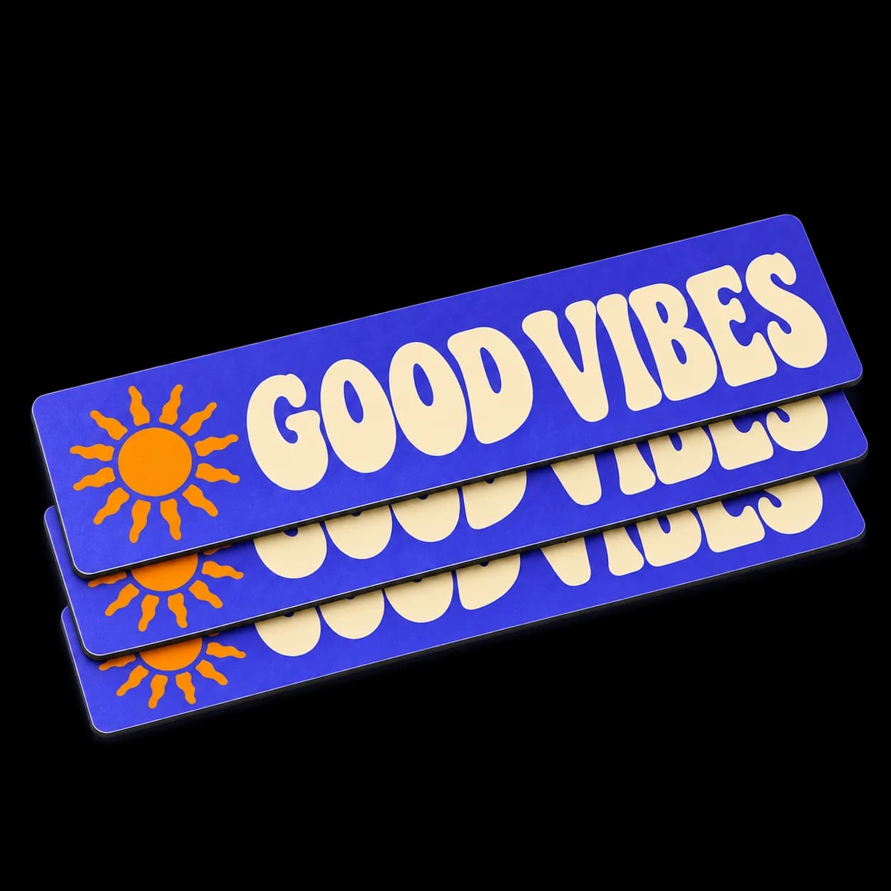 Flat stack of three thin purple Good Vibes magnets with cream lettering, an orange sun, and dark magnetic edges